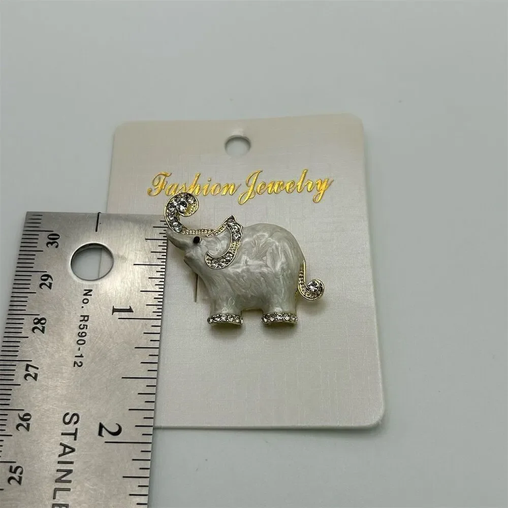 Small Dainty White Elephant Brooch Pin Rhinestone Accents Gold Tone Trunk Up